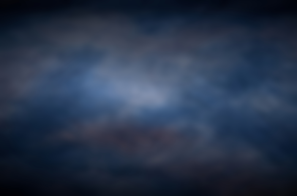 Blurred dark blue blurred background with light in centre