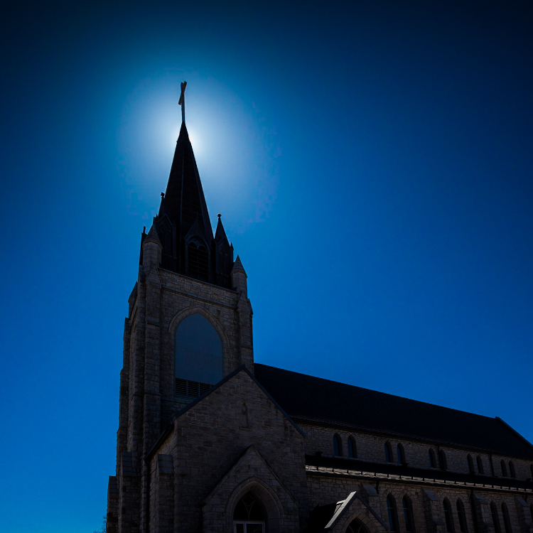 Guardian Angels Exterior with sun behind spire