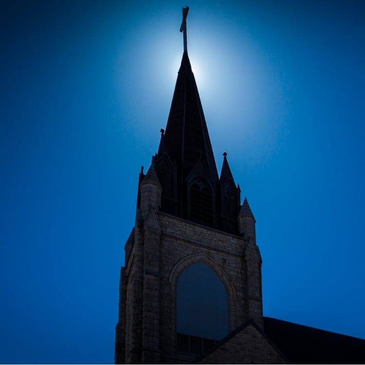 Guardian Angels spire with Sun behind